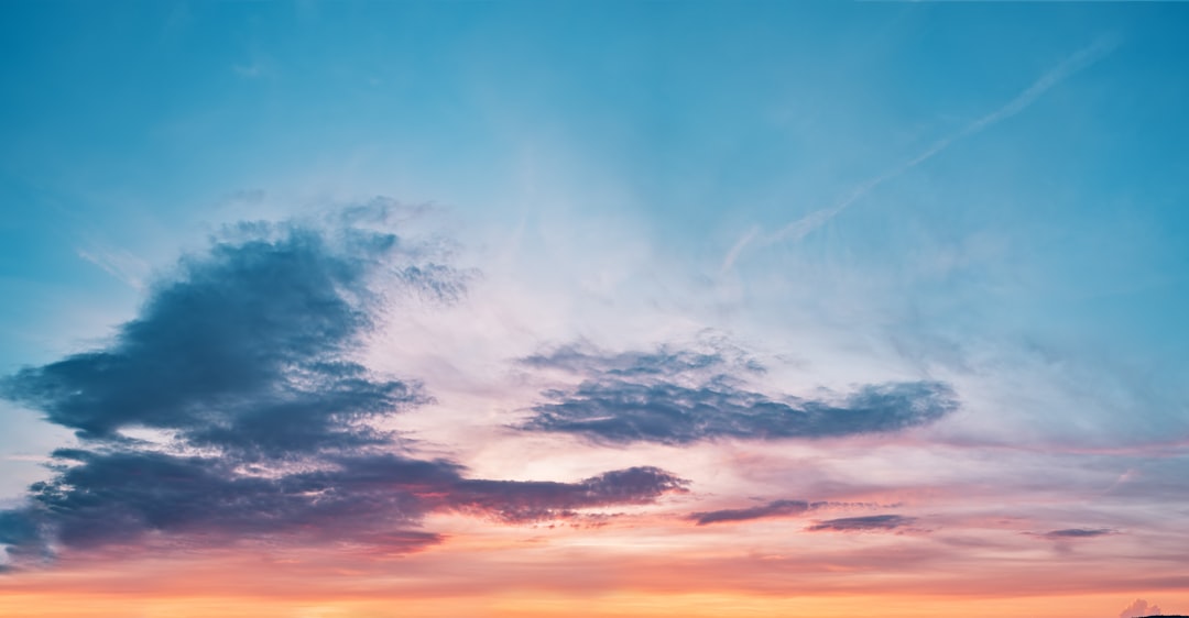 Soft clouds catching warm evening light in a wide open sky