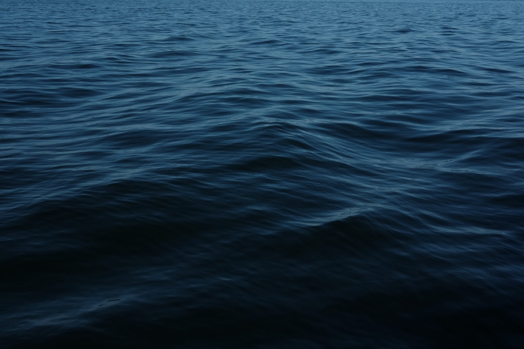 Deep blue ocean water moving gently in soft light